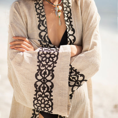Unisex linen and hemp kimono robe with hand-block printed boho pattern, styled as beach cover-up